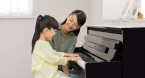 Yamaha Clavinova CLP digital piano with mother and daughter